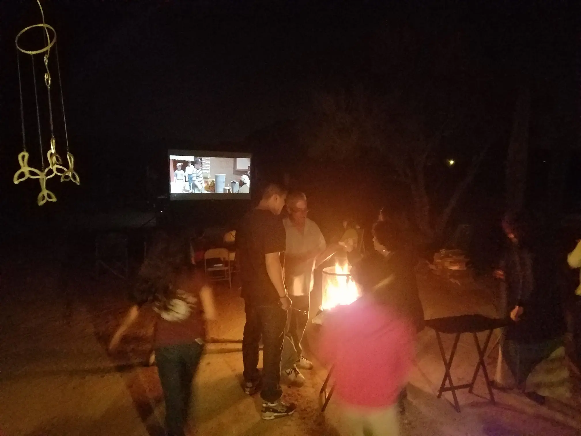 Family watching a movie outdoors